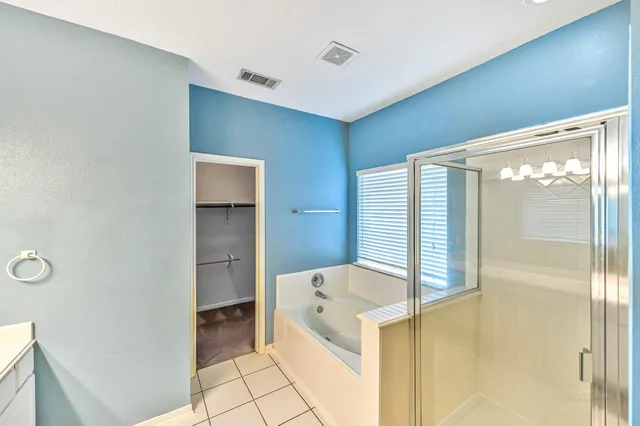 a bathroom with a tub and shower