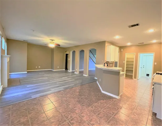a view of a hallway with a sink and a refrigerator
