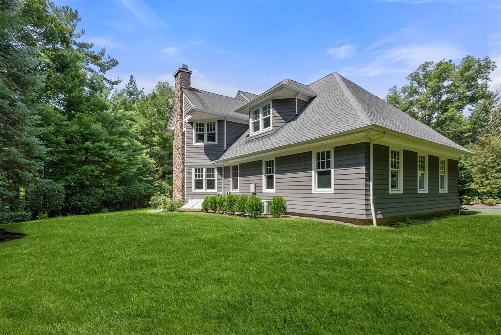 5 Beard Way Wellesley, MA 02482 - Photo 19 of 36 a view of a house with a yard potted plants and a table