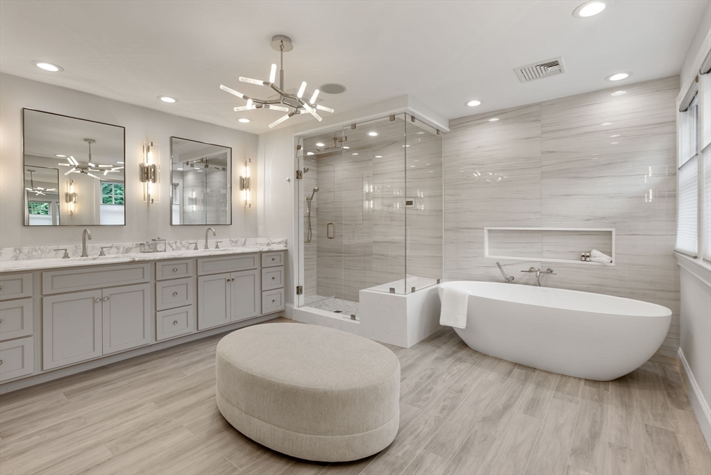 5 Beard Way Wellesley, MA 02482 - Photo 26 of 36 a spacious bathroom with a double vanity sink a large mirror and a bathtub