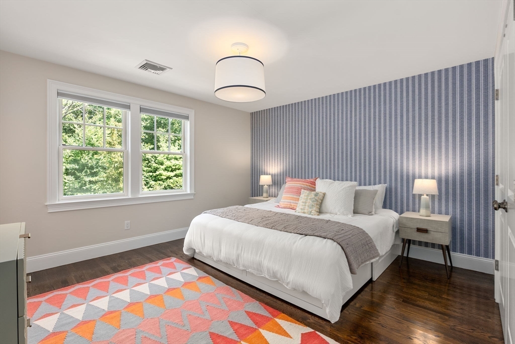 5 Beard Way Wellesley, MA 02482 - Photo 30 of 36 a bedroom with a bed and a lamp