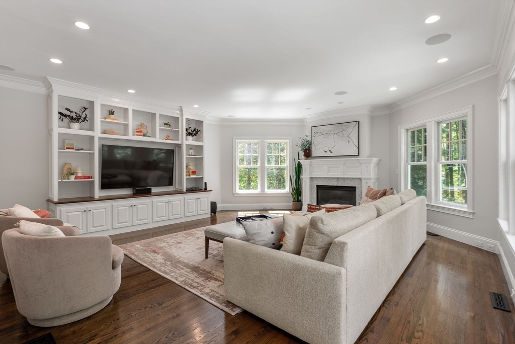 5 Beard Way Wellesley, MA 02482 - Photo 9 of 36 a living room with furniture a flat screen tv and a fireplace