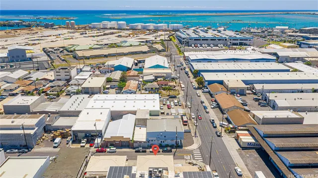 an aerial view of a building with parking and city view