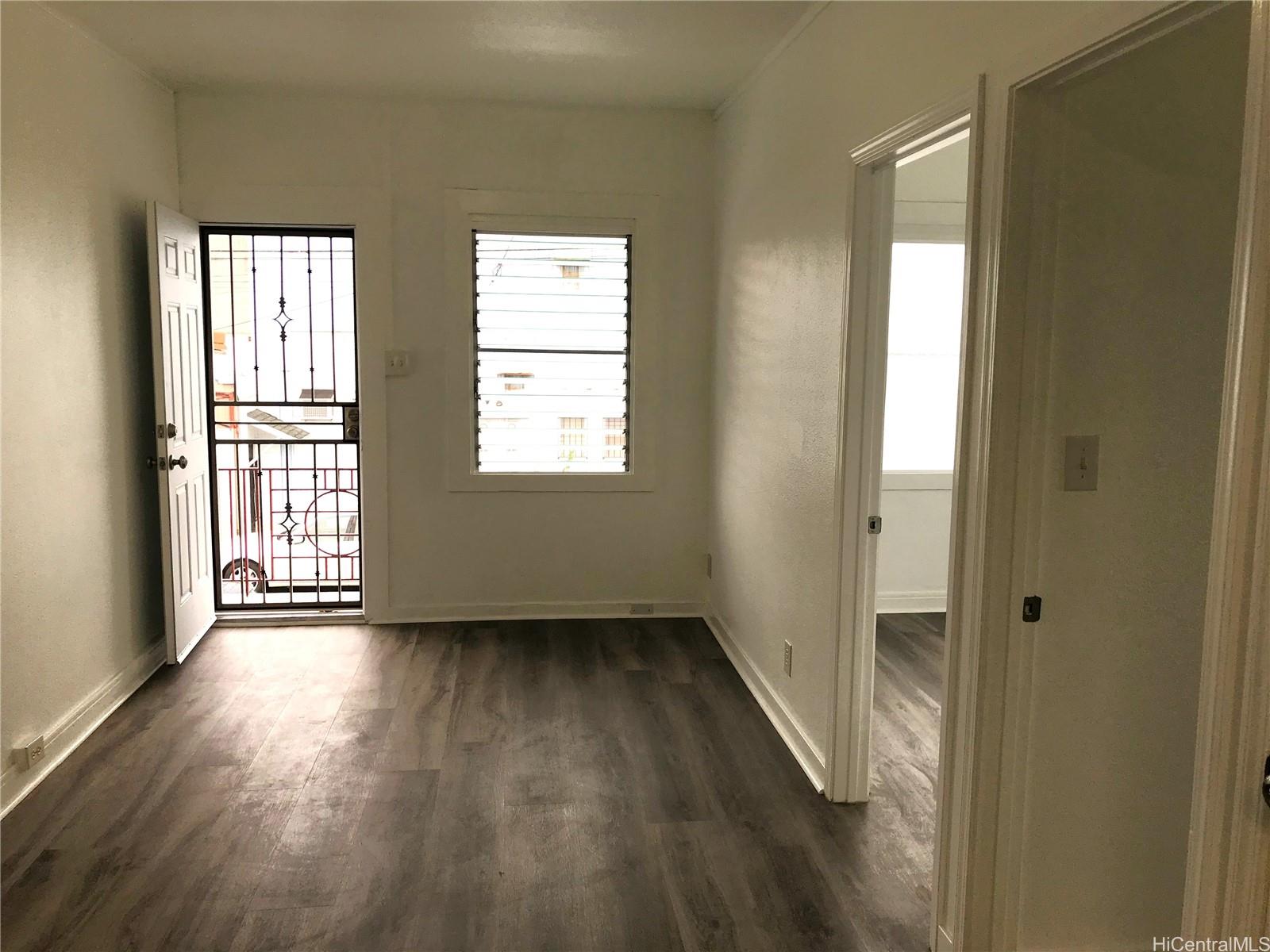 1768 Silva Street Honolulu, HI 96819 - Photo 19 of 22 a view of an empty room with wooden floor and a window