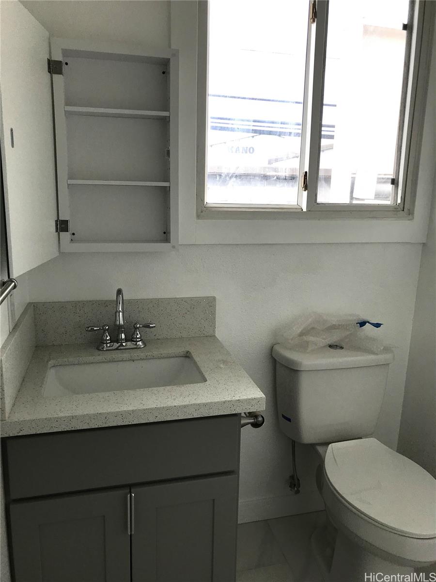 1768 Silva Street Honolulu, HI 96819 - Photo 22 of 22 a bathroom with a toilet sink and window