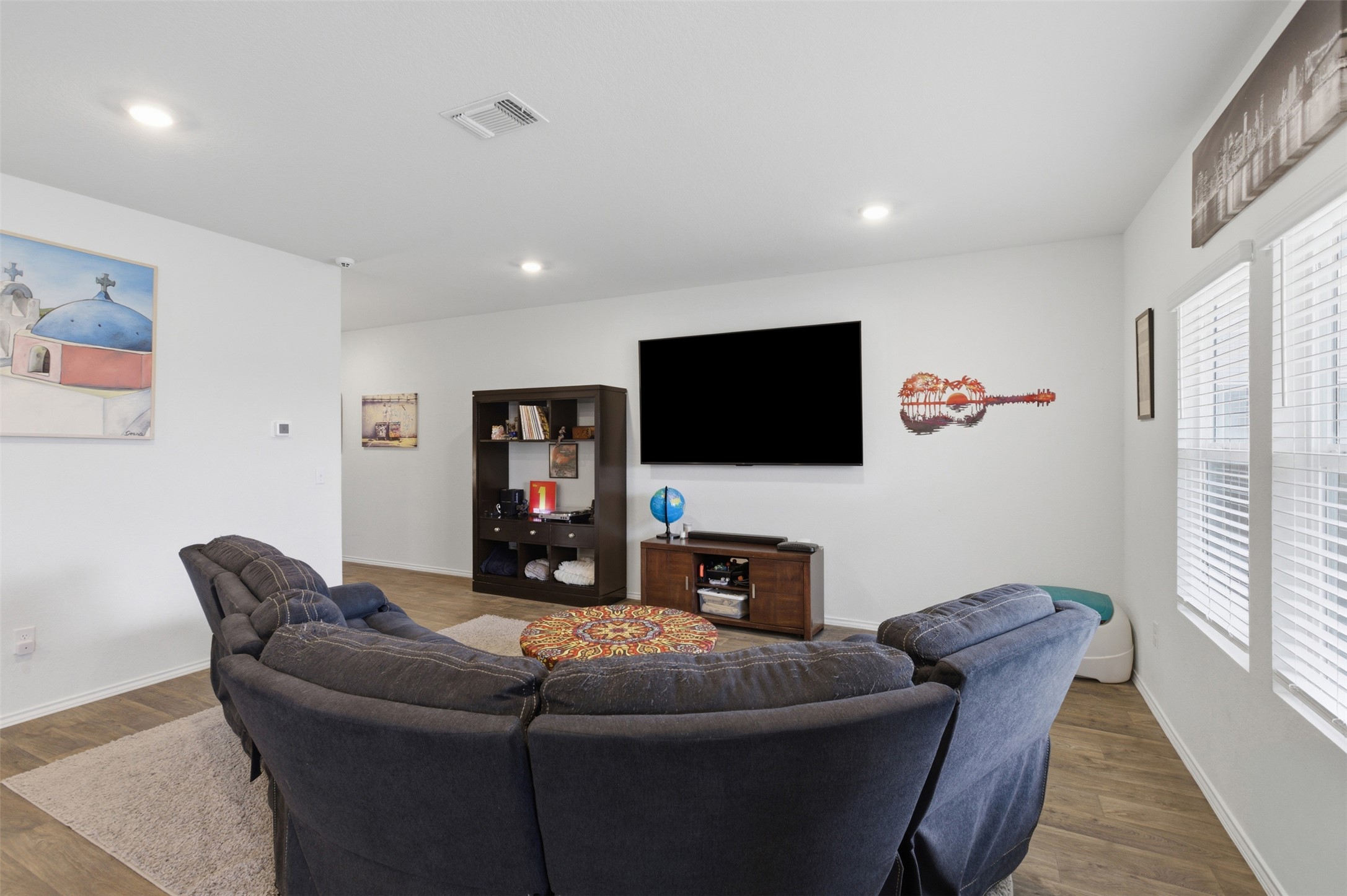 19017 Romano Drive Elgin, TX 78621 - Photo 10 of 33 Spacious living area featuring light wood-finish flooring, recessed lighting, and white interior walls