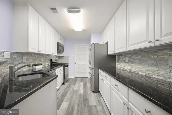 a view of a room with wooden floor and staircase