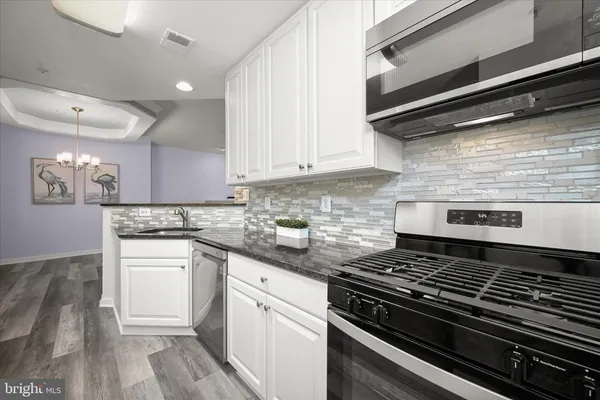 a kitchen with a refrigerator stove and cabinets