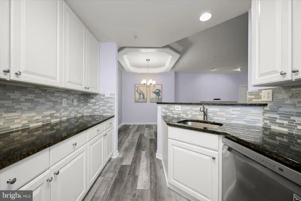 a kitchen with stainless steel appliances granite countertop a stove and a sink