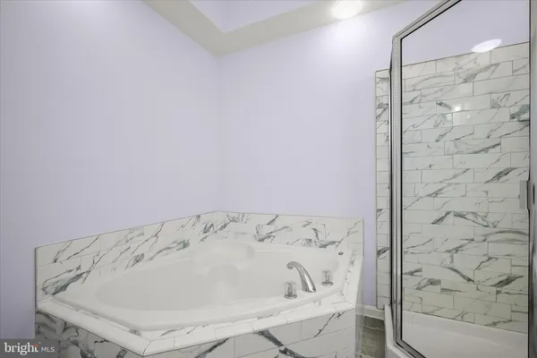 a bathroom with a shower sink and mirror