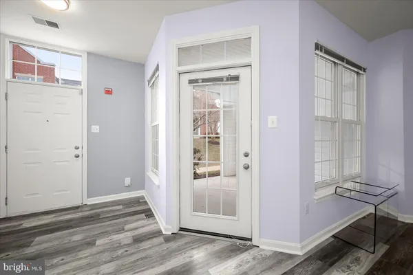 a view of a livingroom with wooden floor and a window