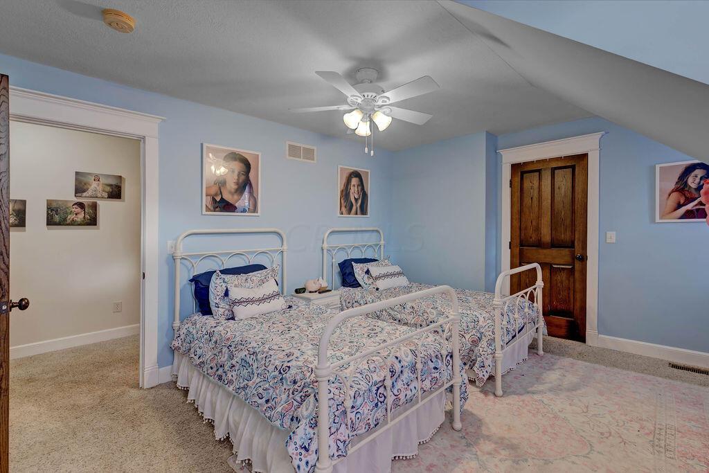 4045 Russell Road Mount Gilead, OH 43338 - Photo 33 of 74 • New gray carpet • Blue painted walls • Walk-in closet • Lighted ceiling fan • Custom built-in drawers