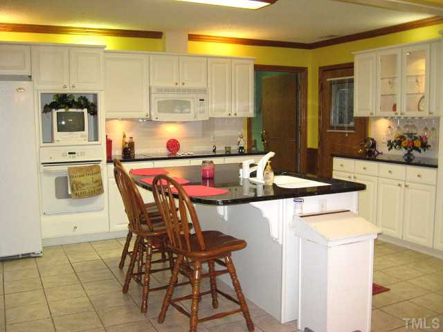 3817 Cheek Road Durham, NC 27704 - Photo 2 of 18 Updated kitchen with granite counters, ceramic tile backsplash, & breakfast bar Kitchen