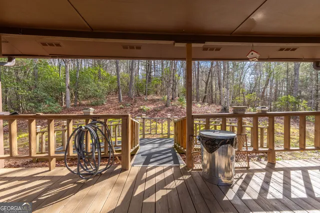 a view of a patio with a table chairs and wooden floor