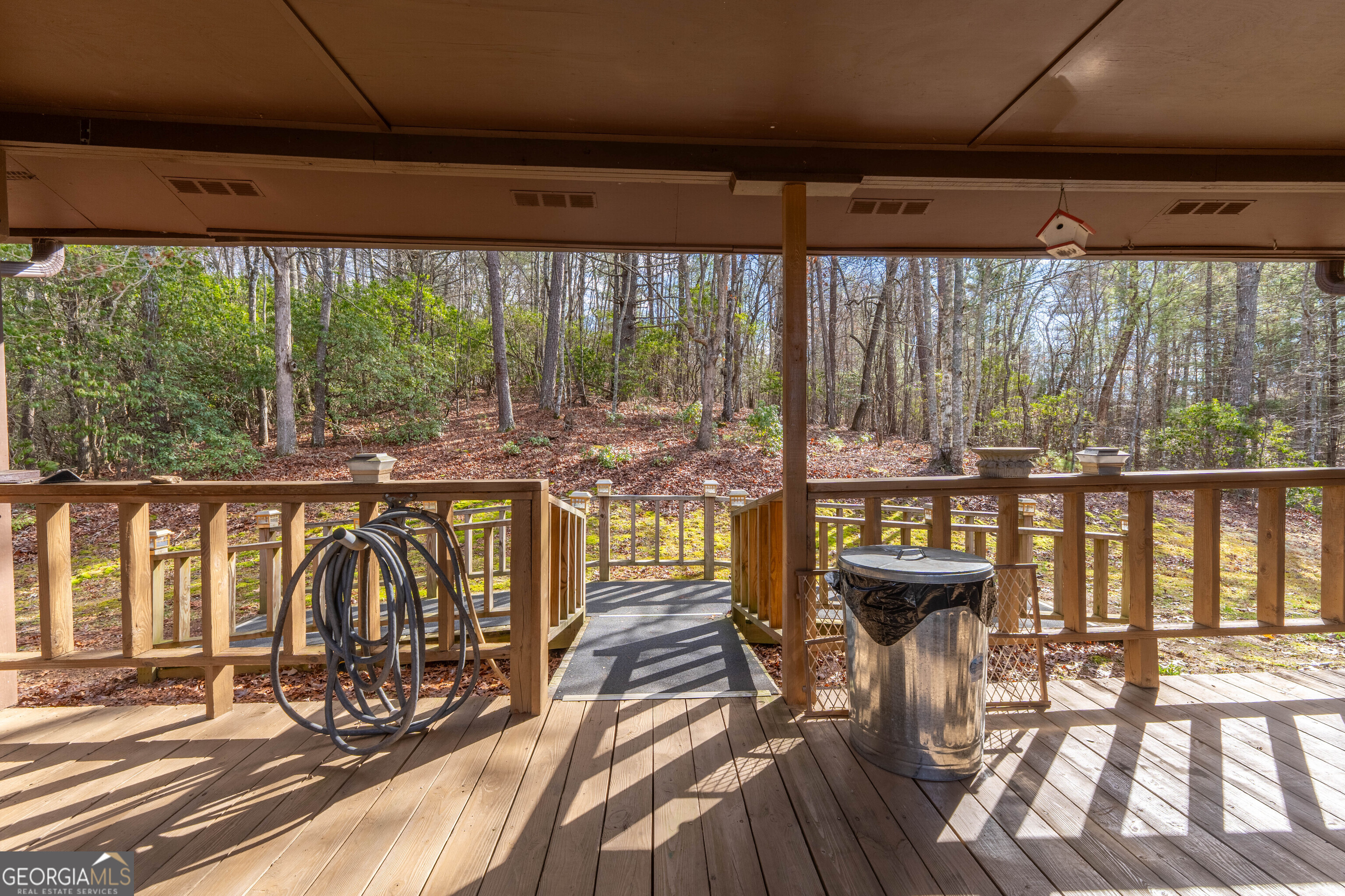 300 Sandy Gap Road Murphy, NC 28906 - Photo 15 of 48 a view of a patio with a table chairs and wooden floor