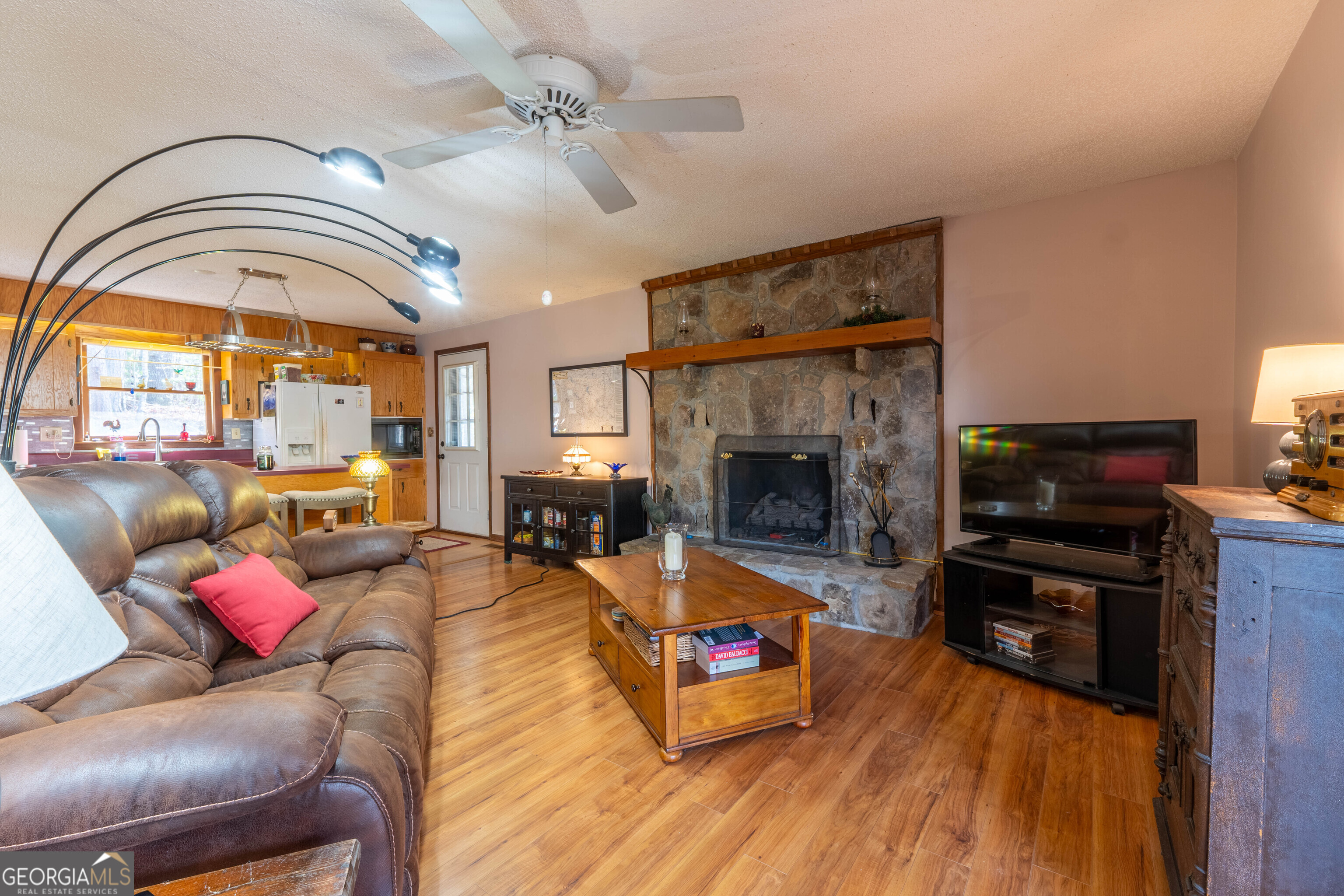 300 Sandy Gap Road Murphy, NC 28906 - Photo 19 of 48 a living room with furniture a fireplace and a flat screen tv