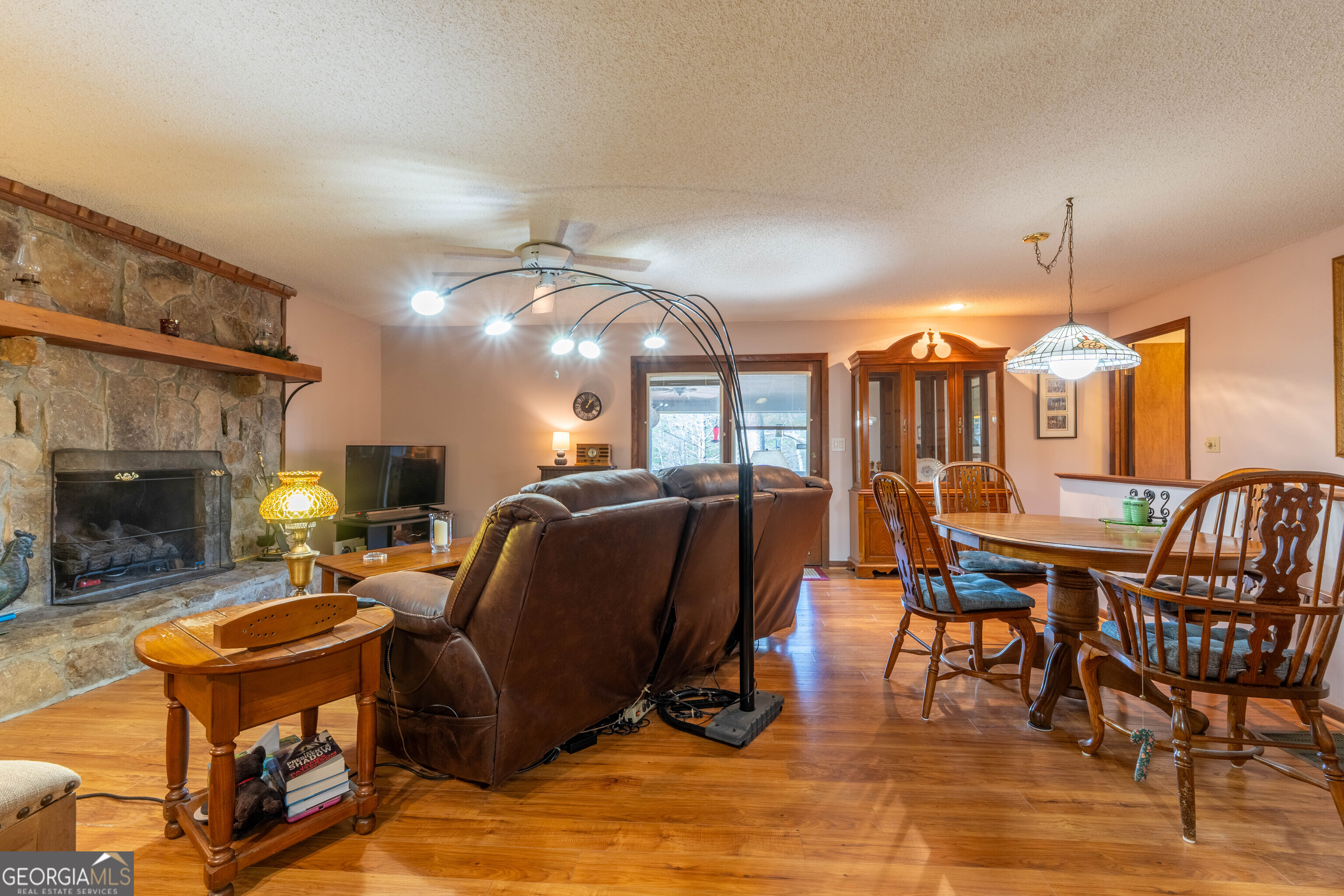 300 Sandy Gap Road Murphy, NC 28906 - Photo 20 of 48 a living room with furniture a fireplace and a dining table with wooden floor