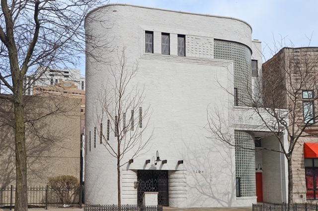 a front view of a house with a tree