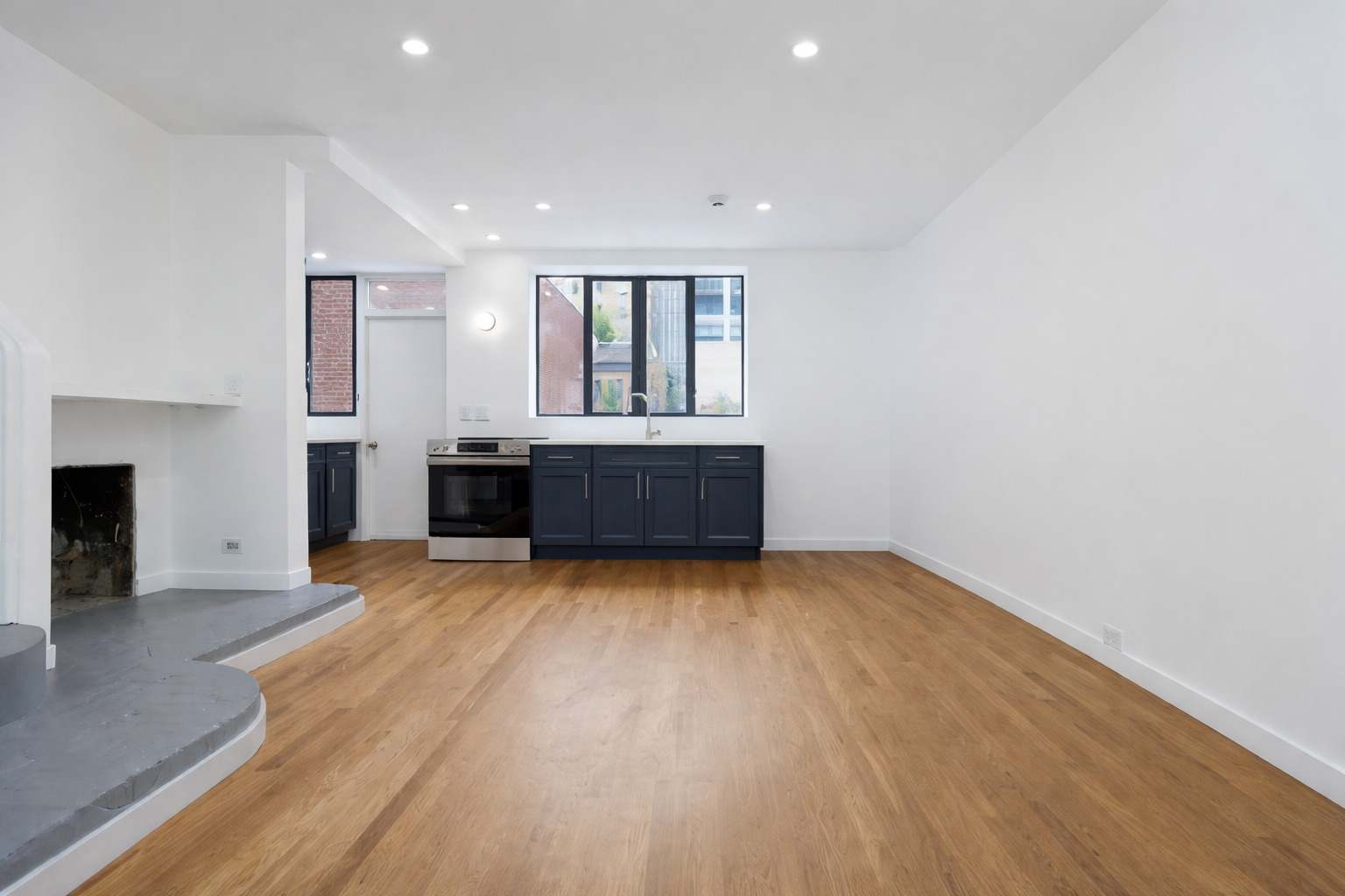 1209 North State Street, Unit 11 Chicago, IL 60611 - Photo 2 of 11 an empty room with wooden floor and fireplace