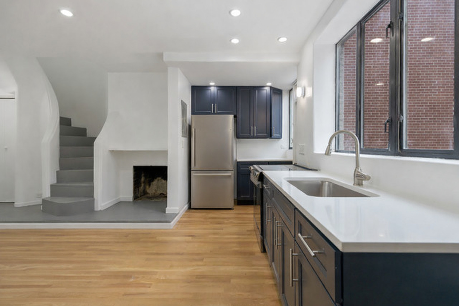 1209 North State Street, Unit 11 Chicago, IL 60611 - Photo 4 of 11 a kitchen with stainless steel appliances granite countertop a sink stove and refrigerator