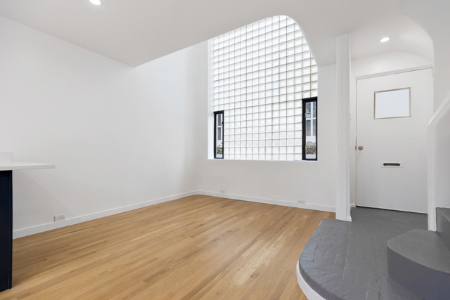 1209 North State Street, Unit 11 Chicago, IL 60611 - Photo 6 of 11 an empty room with wooden floor