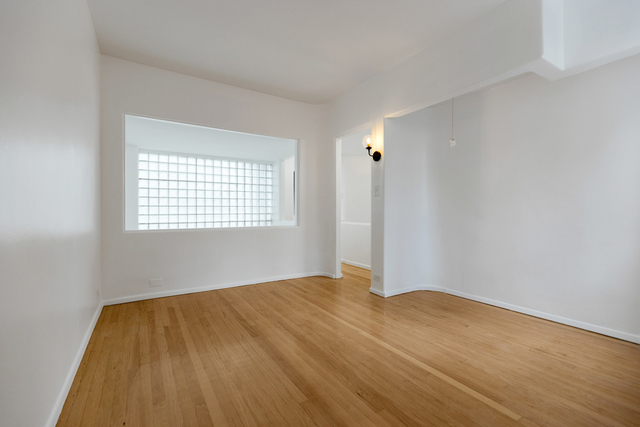 1209 North State Street, Unit 11 Chicago, IL 60611 - Photo 9 of 11 a view of empty room with wooden floor