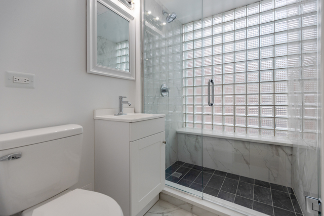 1209 North State Street, Unit 11 Chicago, IL 60611 - Photo 10 of 11 a bathroom with a sink toilet and shower