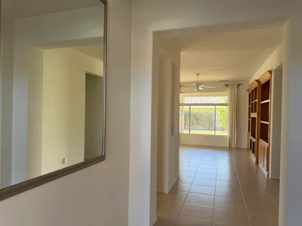 a view of hallway with livingroom and a window