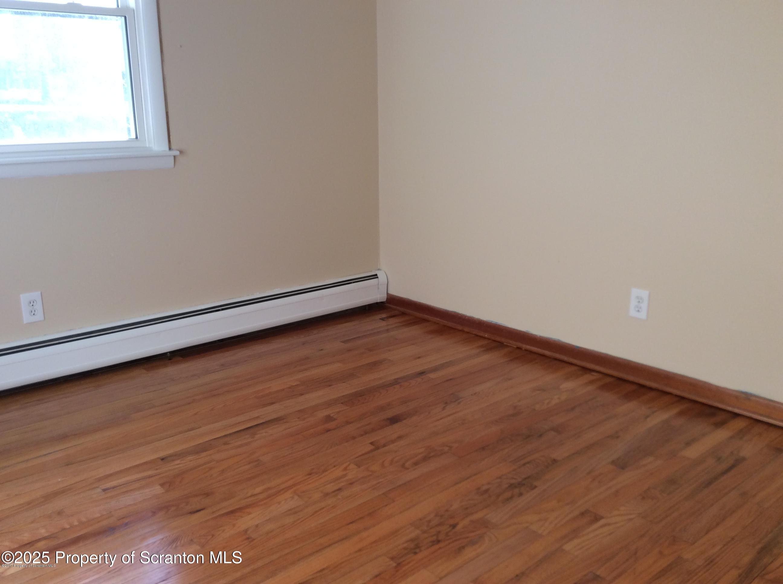 410 /412 Lane Hill Road Tunkhannock, PA 18657 - Photo 12 of 16 an empty room with wooden floor and windows