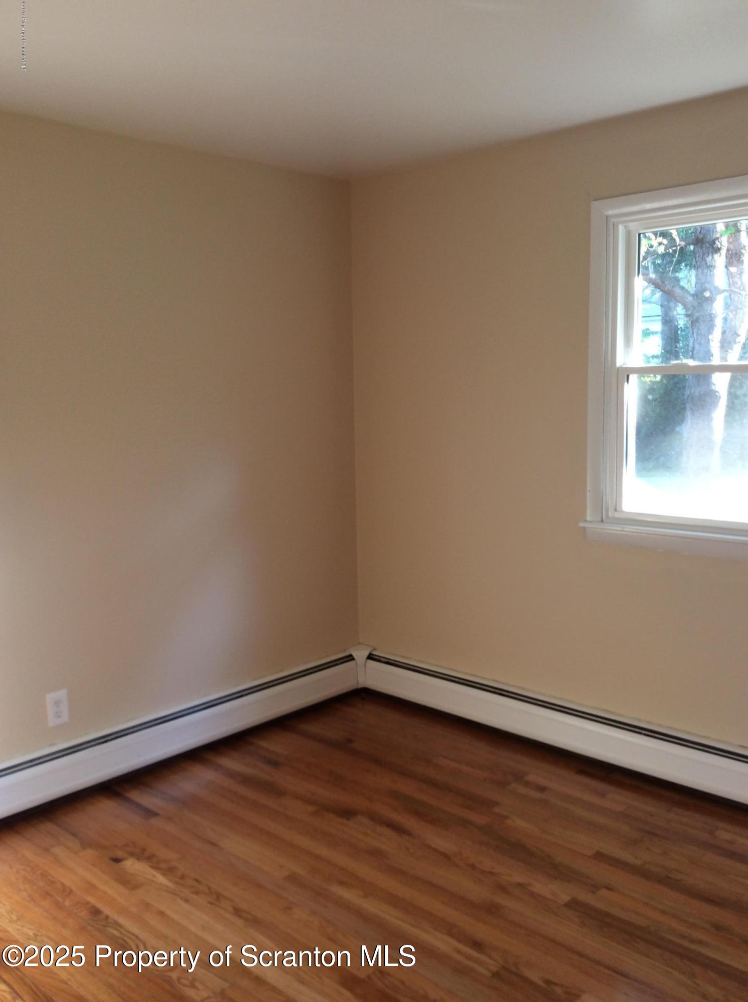 410 /412 Lane Hill Road Tunkhannock, PA 18657 - Photo 13 of 16 a view of an empty room with wooden floor and a window