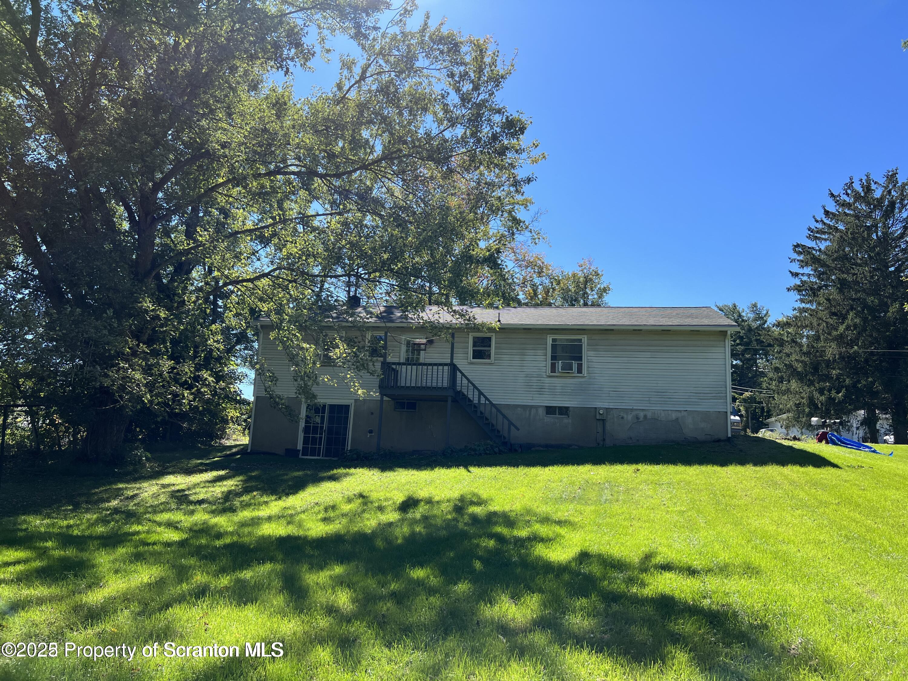 410 /412 Lane Hill Road Tunkhannock, PA 18657 - Photo 3 of 16 a view of a yard in front of a house with large tree