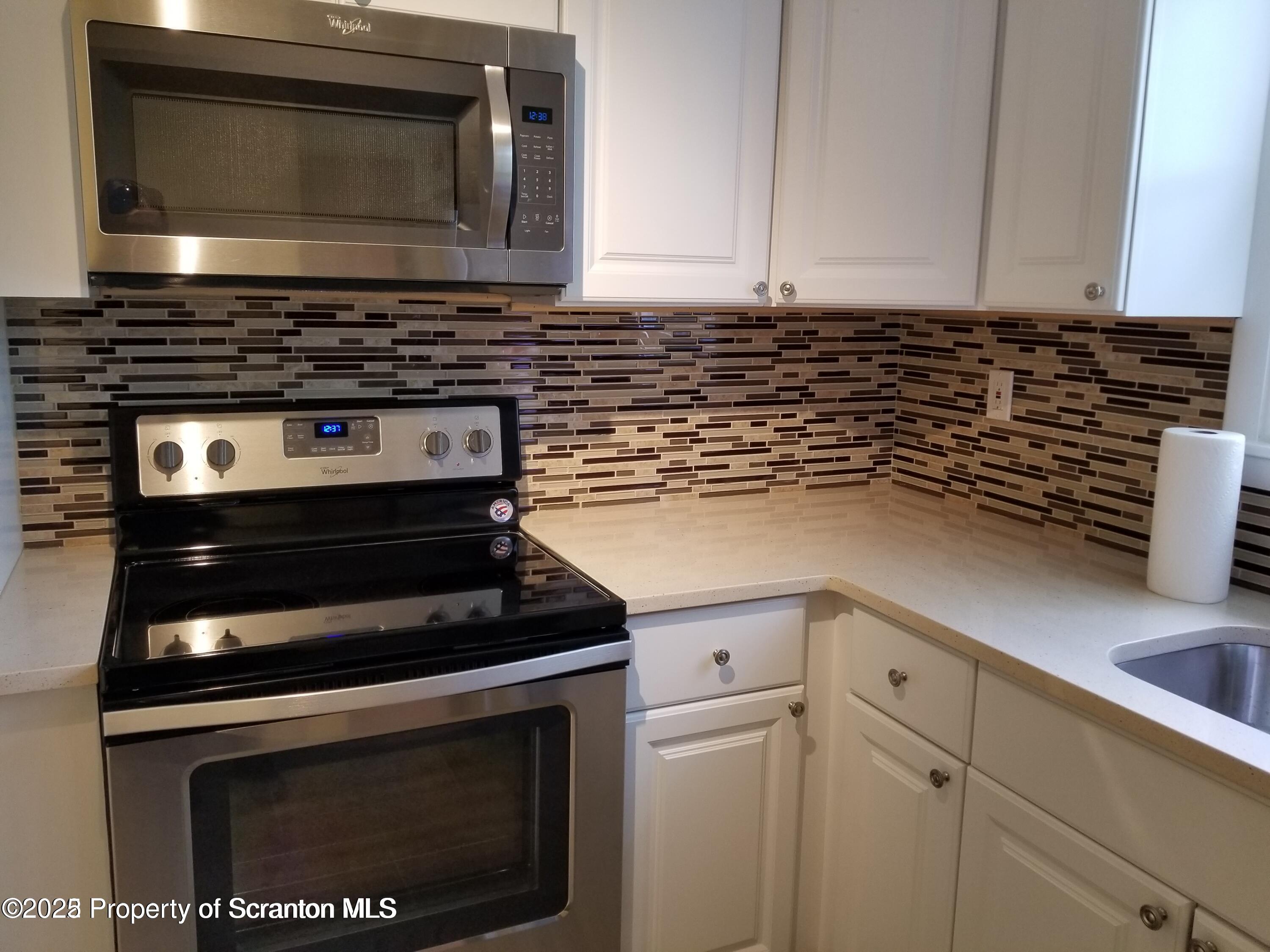 410 /412 Lane Hill Road Tunkhannock, PA 18657 - Photo 5 of 16 a kitchen with stove top oven and cabinets