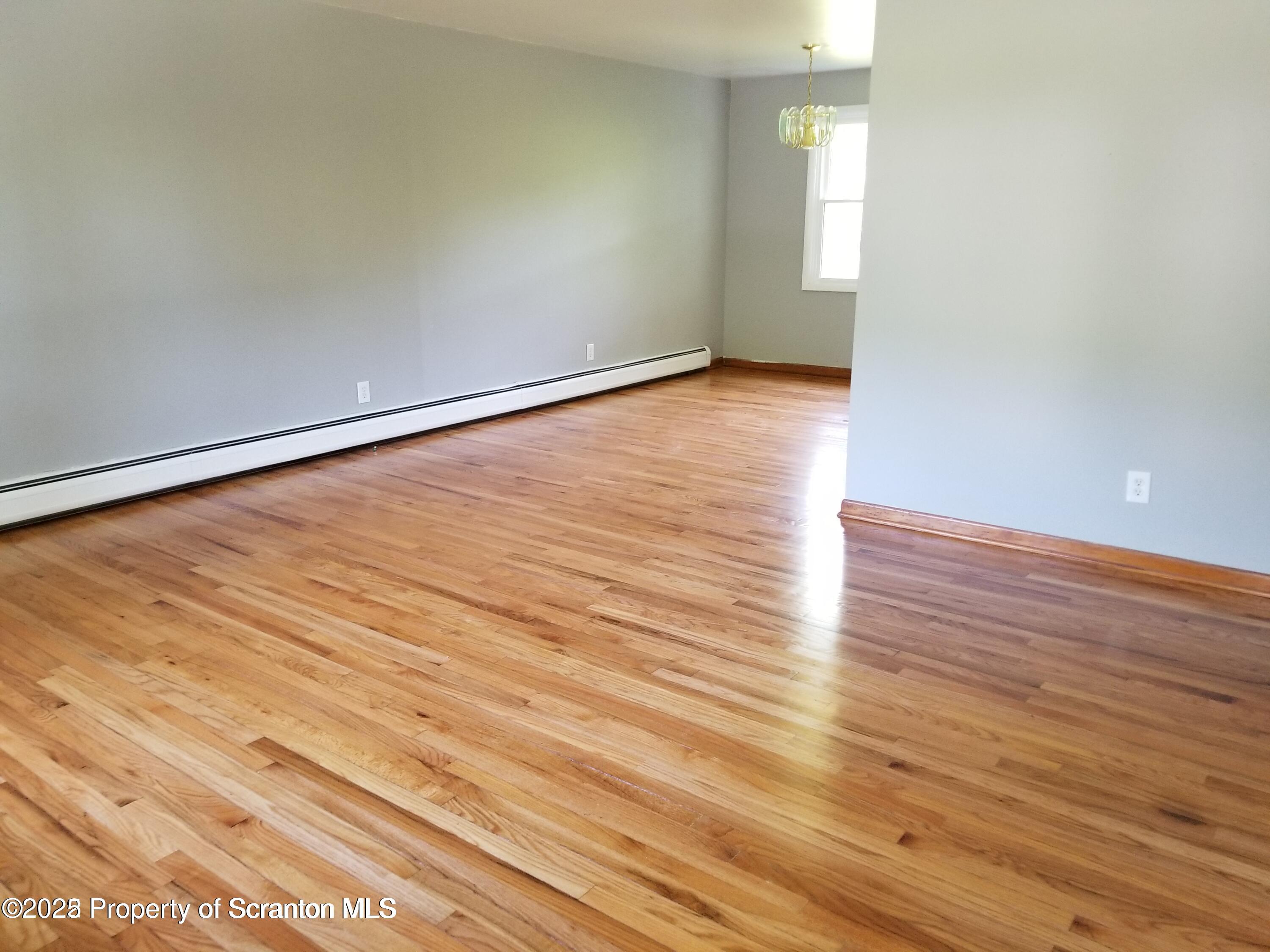 410 /412 Lane Hill Road Tunkhannock, PA 18657 - Photo 7 of 16 a view of an empty room and wooden floor