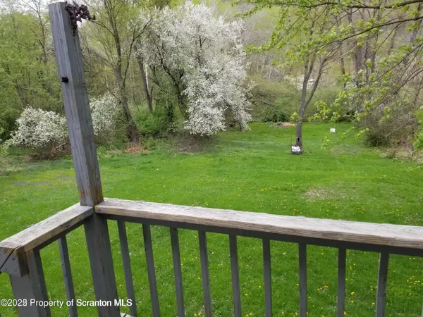 a view of a balcony with a yard