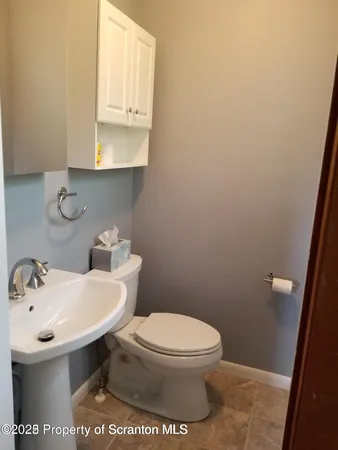 a bathroom with a sink a toilet and mirror