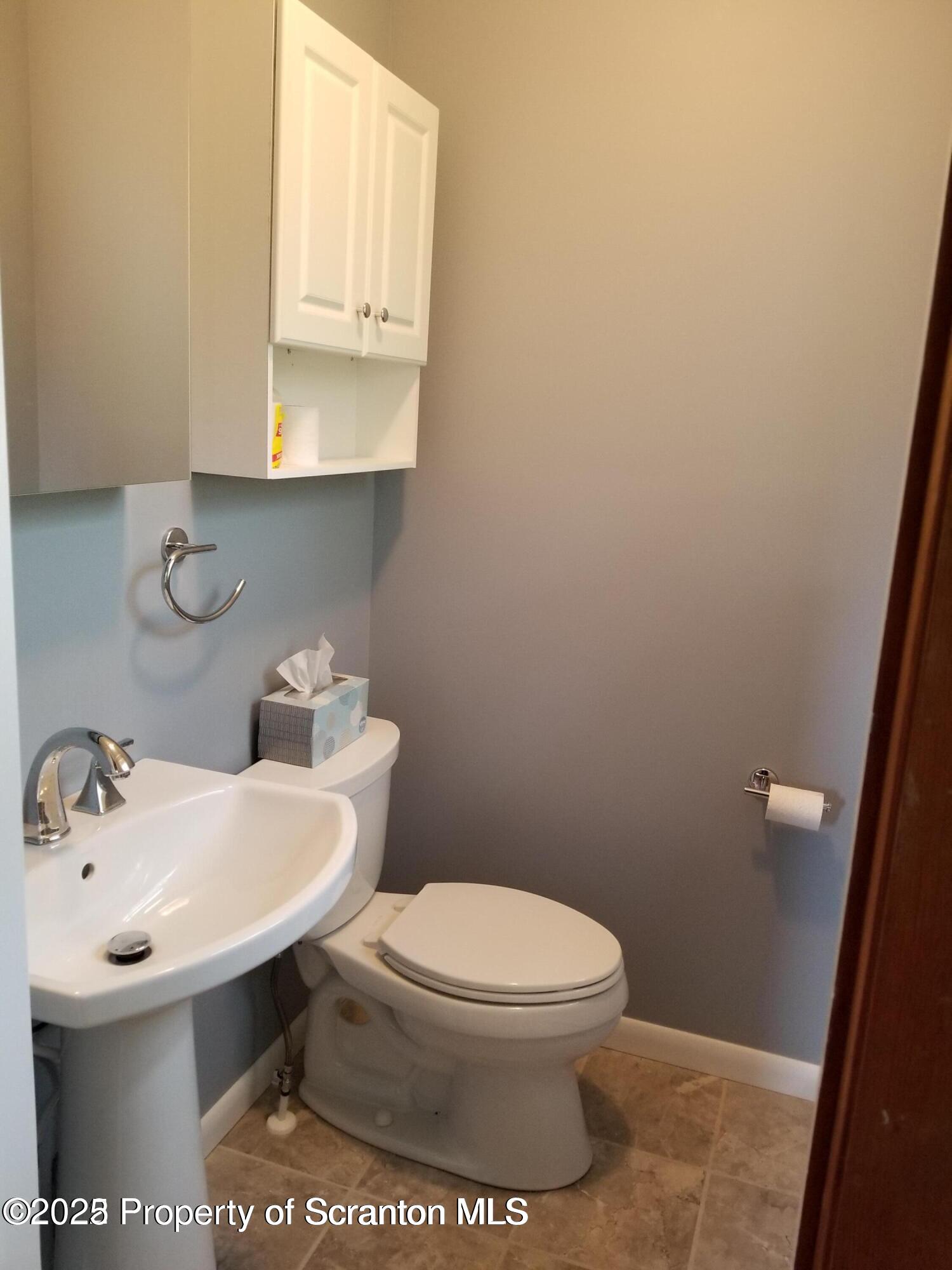 410 /412 Lane Hill Road Tunkhannock, PA 18657 - Photo 10 of 16 a bathroom with a sink a toilet and mirror