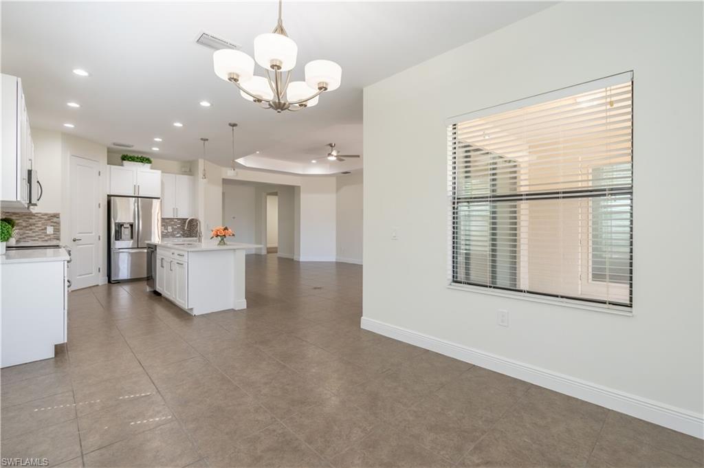 3549 Canopy Circle Naples, FL 34120 - Photo 17 of 50 a view of a kitchen with furniture and a window