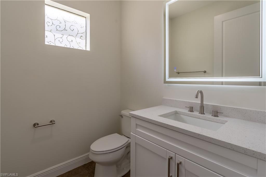 3549 Canopy Circle Naples, FL 34120 - Photo 20 of 50 a bathroom with a toilet sink and mirror
