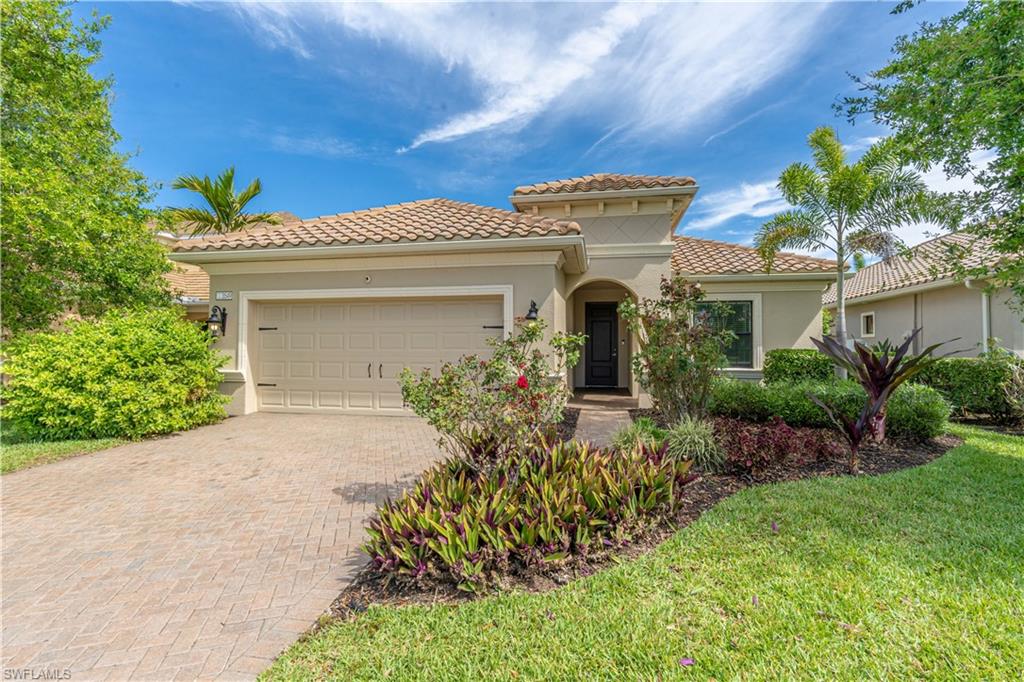 3549 Canopy Circle Naples, FL 34120 - Photo 2 of 50 a front view of a house with a yard
