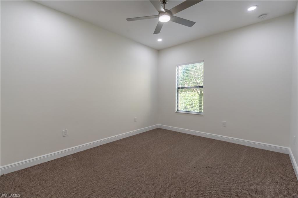 3549 Canopy Circle Naples, FL 34120 - Photo 21 of 50 an empty room with a window and a fan