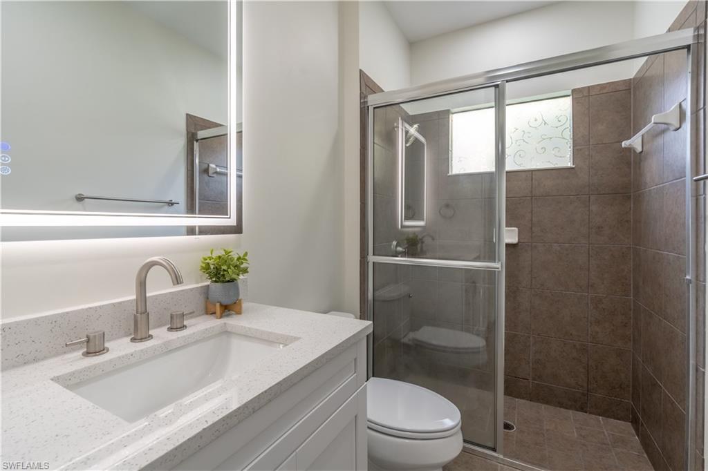 3549 Canopy Circle Naples, FL 34120 - Photo 23 of 50 a bathroom with a sink a toilet and shower