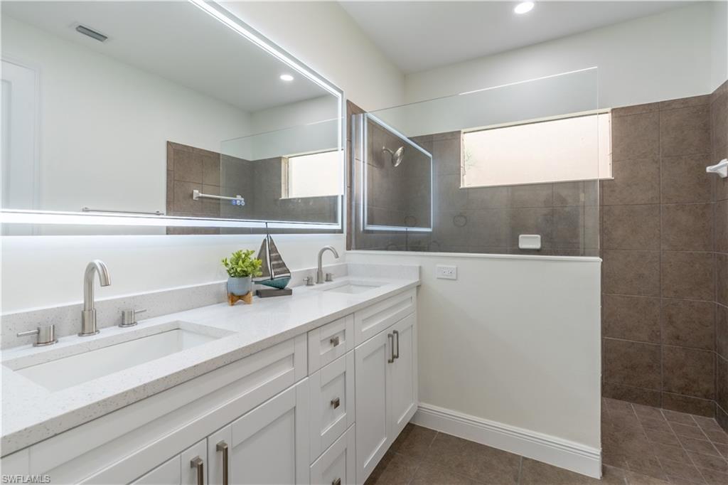 3549 Canopy Circle Naples, FL 34120 - Photo 25 of 50 a bathroom with a sink and a mirror