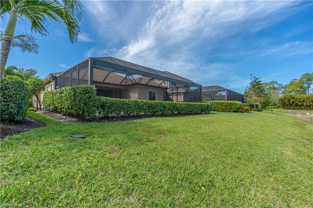3549 Canopy Circle Naples, FL 34120 - Photo 44 of 50 a front view of a house with a garden