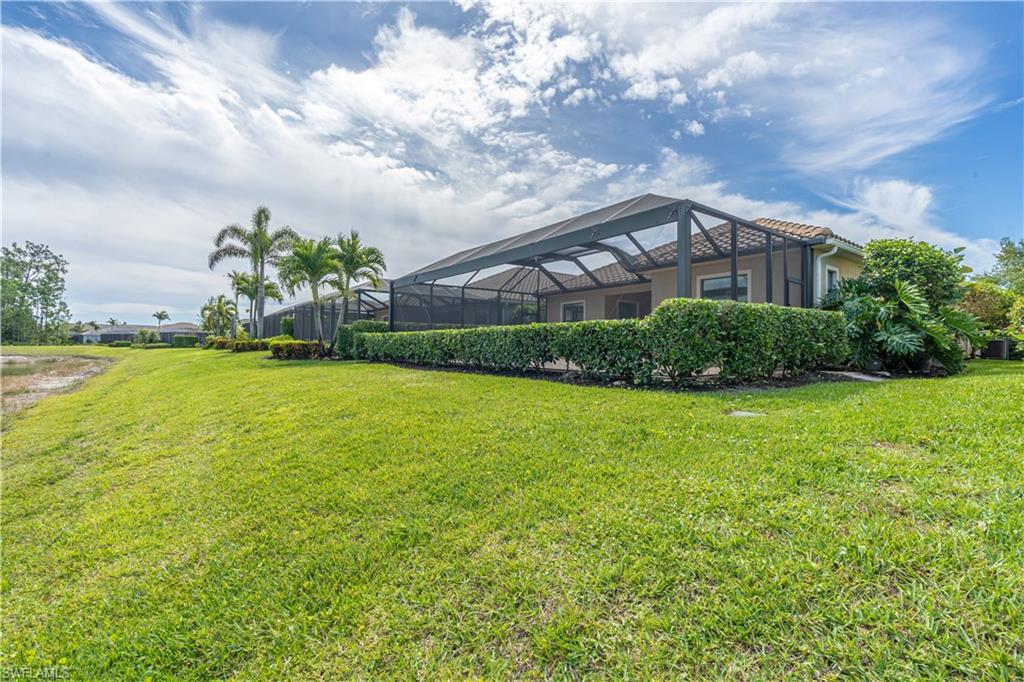3549 Canopy Circle Naples, FL 34120 - Photo 45 of 50 a front view of a house with a yard