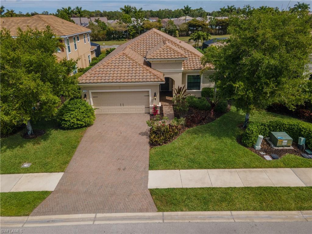 3549 Canopy Circle Naples, FL 34120 - Photo 48 of 50 a front view of a house with a yard and garage