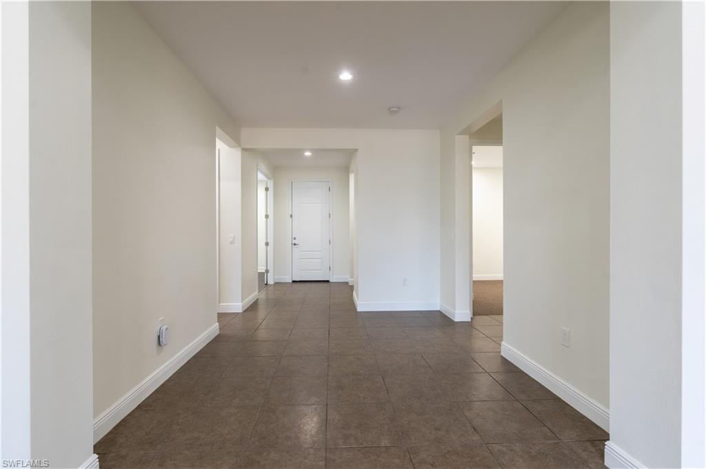3549 Canopy Circle Naples, FL 34120 - Photo 6 of 50 a view of a big room with closet and chandelier fan