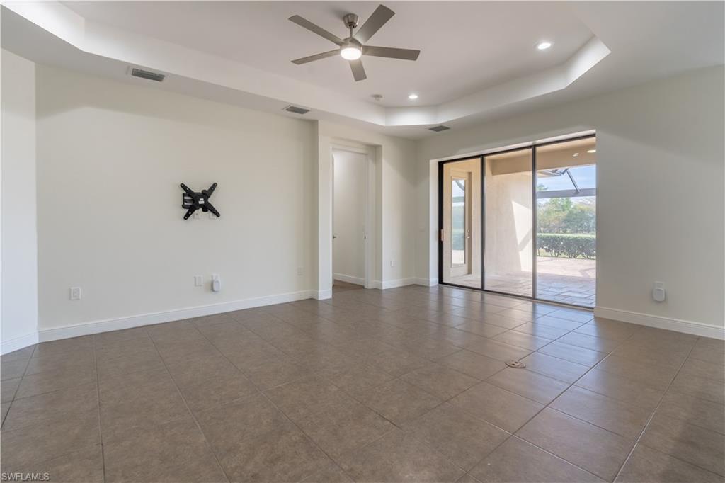 3549 Canopy Circle Naples, FL 34120 - Photo 9 of 50 wooden floor in an empty room with a window