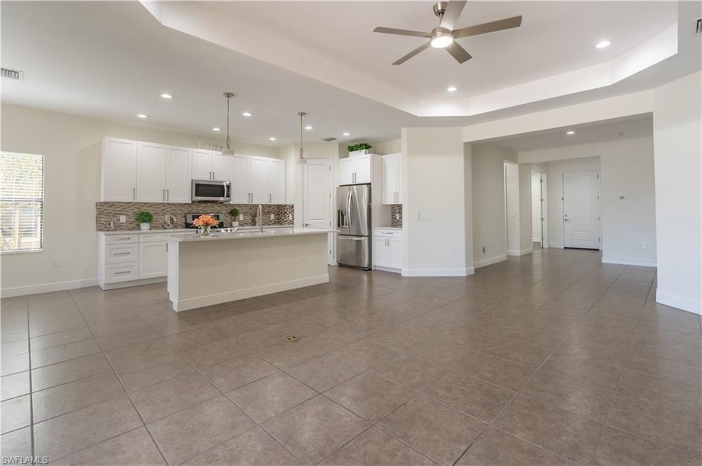 3549 Canopy Circle Naples, FL 34120 - Photo 10 of 50 a view of a kitchen with a sink and a stove top oven