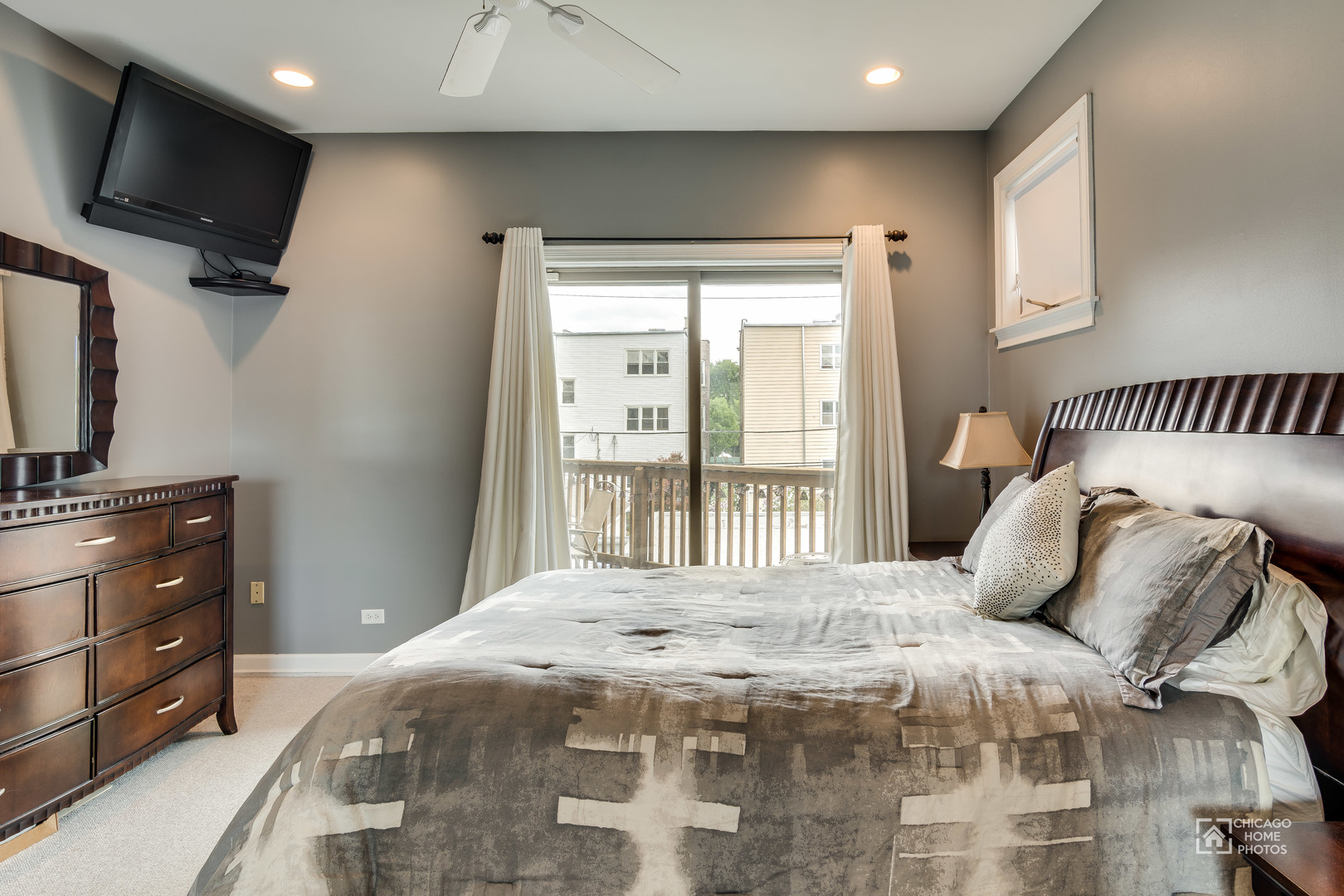 2128 West Walton Street, Unit 2E Chicago, IL 60622 - Photo 13 of 23 a bedroom with a balcony a bed and a television