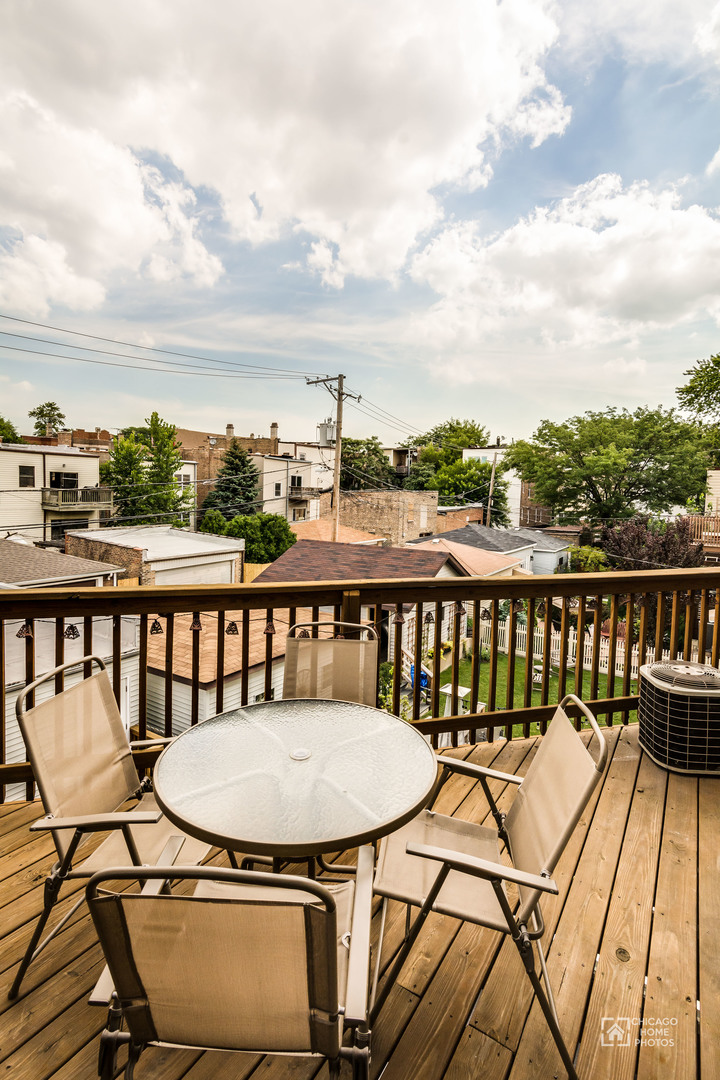 2128 West Walton Street, Unit 2E Chicago, IL 60622 - Photo 23 of 23 a view of a balcony with wooden floor and iron fence
